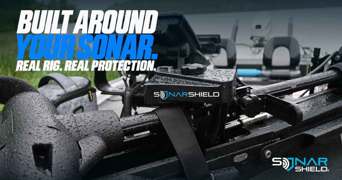 Genuine Sonar Shield travel covers and fastening strap photographed on a stowed trolling-motor setup aboard a fishing boat beside a lake